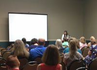 Kathy Kuhl speaking to parents at a convention